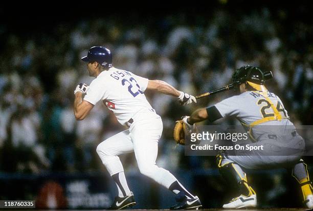 Kirk Gibson of the Los Angeles Dodgers swing and hits a game winning pitch-hit home run in the bottom of the ninth inning of game one against the...