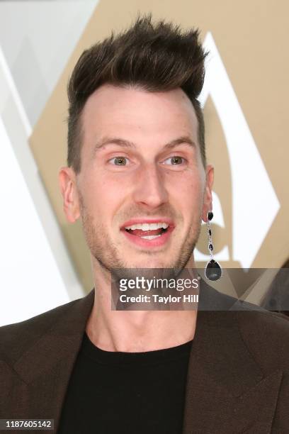 Russell Dickerson wins a bet by wearing his girlfriend's earring on the red carpet of the 53nd annual CMA Awards at Bridgestone Arena on November 13,...