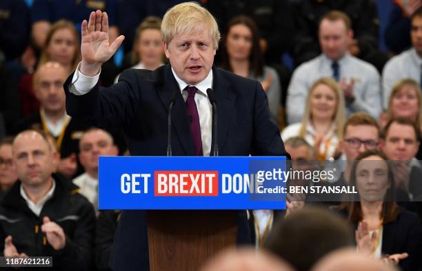 Britain's Prime Minister and Conservative party leader Boris Johnson speaks during a general election campaign event at JCB construction company in...