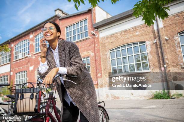 business woman with bicycle outdoors - global mindset stock pictures, royalty-free photos & images