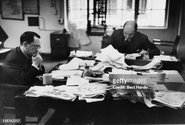 Sub-editors at work on a Saturday afternoon in the newsroom at the offices of the News of The World, April 1953. Original Publication : Picture Post...