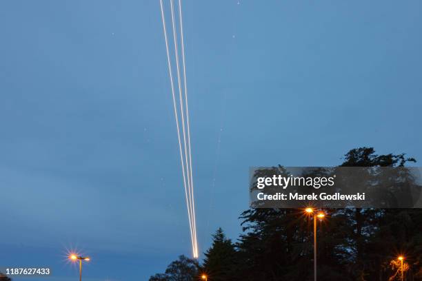 airplane light trails at dublin airport - the dublin airport stock pictures, royalty-free photos & images