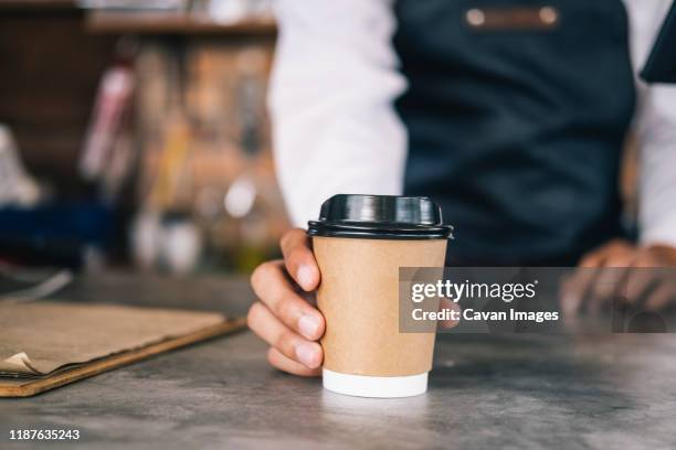 young owner of coffee cafe service customer. - coffe to go stockfoto's en -beelden