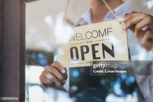 young startup coffee cafe owener open and welcome customer. - newly opened stock pictures, royalty-free photos & images