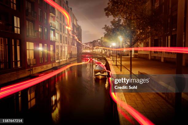 red light phenomena through the darkness of the city - copenhagen night stock pictures, royalty-free photos & images