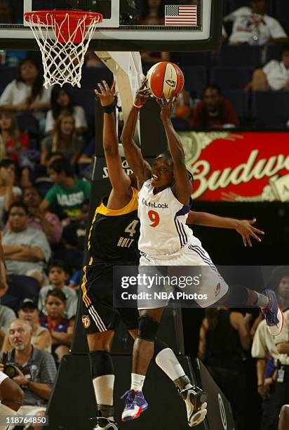 Marie Ferdinand-Harris of the Phoenix Mercury jumps for a rebound against Amber Holt of the Tulsa Shock in a WNBA game played on July 10 at U.S....