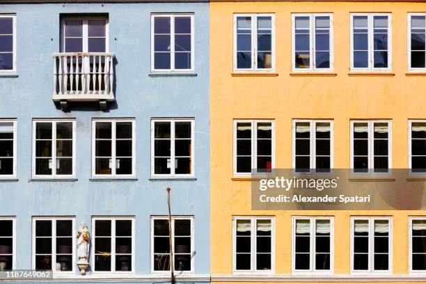 house facade with windows in copenhagen, denmark - halved stockfoto's en -beelden