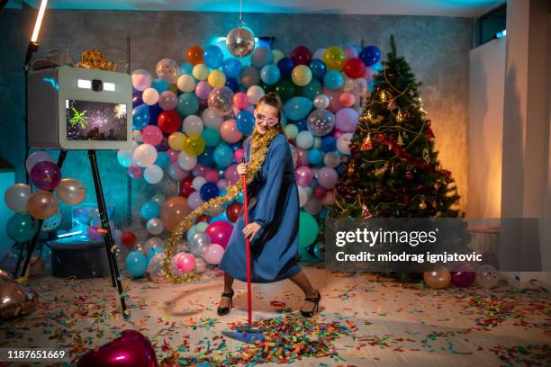 funny woman having good time while cleaning after party - nerd fun stock pictures, royalty-free photos & images