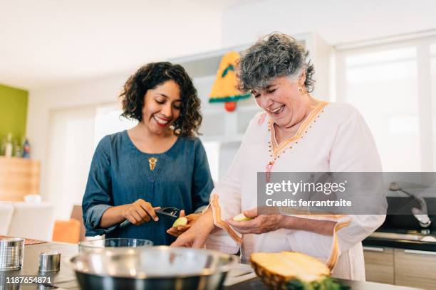 mother and daughter preparing the christmas meal - pineapple cut stock pictures, royalty-free photos & images