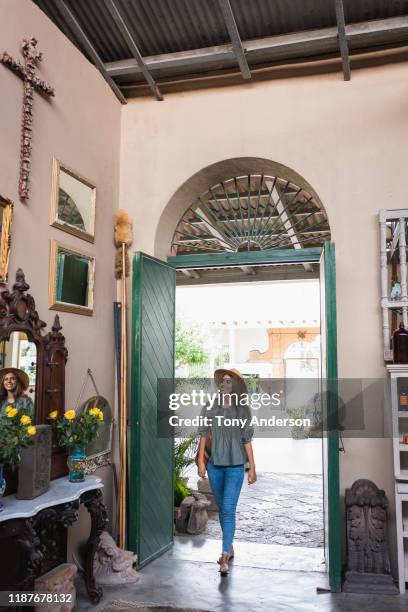 young woman shopping in an antique shop - woman-looking-into-mirror-full-body stock pictures, royalty-free photos & images
