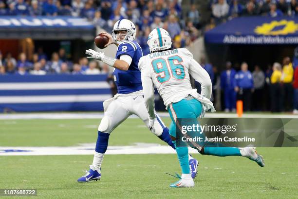 Brian Hoyer of the Indianapolis Colts scrambles while being chased by Taco Charlton of the Miami Dolphins at Lucas Oil Stadium on November 10, 2019...