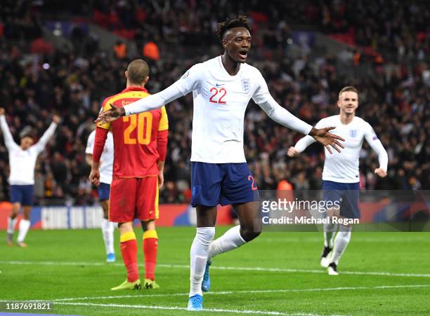 Tammy Abraham of England celebrates after scoring his sides seventh goal with Jadon Sancho during the UEFA Euro 2020 qualifier between England and...