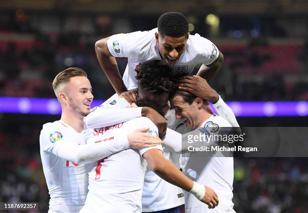 Tammy Abraham of England celebrates after scoring his sides seventh goal with team mates during the UEFA Euro 2020 qualifier between England and...
