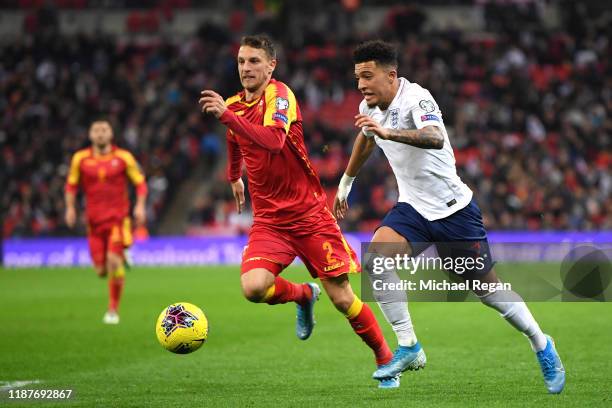 Jadon Sancho of England is closed down by Momcilo Raspopovic of Montenegro during the UEFA Euro 2020 qualifier between England and Montenegro at...