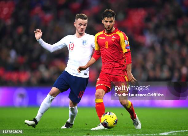 James Maddison of England and Deni Hocko of Montenegro during the UEFA Euro 2020 qualifier between England and Montenegro at Wembley Stadium on...