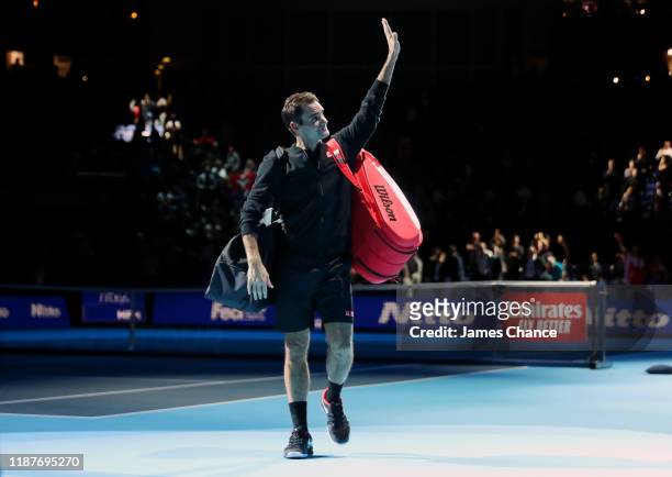 Roger Federer of Switzerland acknowledges the fans as he walks off the court after his singles match victory against Novak Djokovic of Serbia during...
