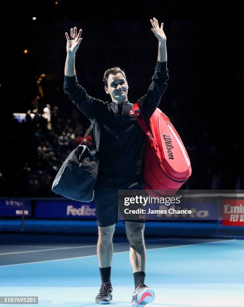 Roger Federer of Switzerland acknowledges the fans as he walks off the court after his singles match victory against Novak Djokovic of Serbia during...