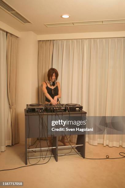 young woman djing in living room - djiang stock pictures, royalty-free photos & images