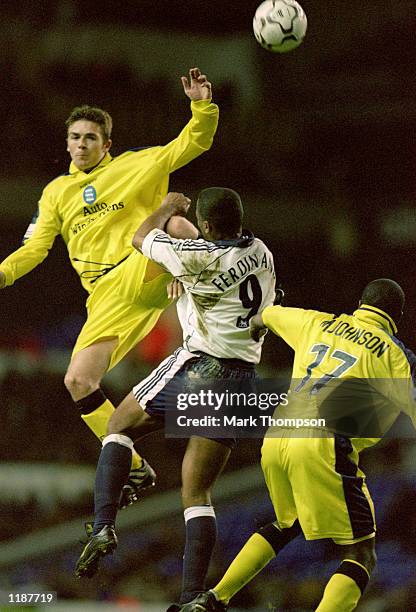 Bryan Hughes and Michael Johnson of Birmingham City challenge Les Ferdinand of Tottenham Hotspur during the Worthington Cup third round match at...