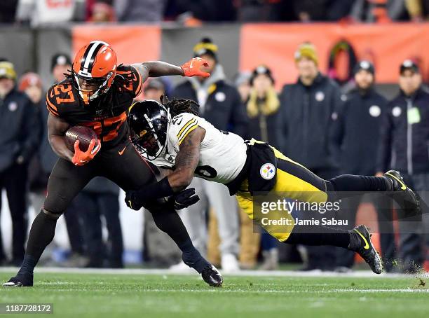 Running back Kareem Hunt of the Cleveland Browns is tackle by inside linebacker Mark Barron of the Pittsburgh Steelers during the game at FirstEnergy...