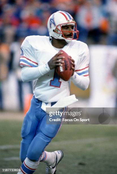 Warren Moon of the Houston Oilers drops back to pass against the Denver Broncos during the AFC Divisional Playoff Game January 10, 1988 at Mile High...