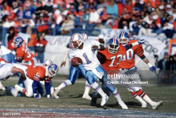 Warren Moon of the Houston Oilers scrambles away from the pressure against the Denver Broncos during the AFC Divisional Playoff Game January 10, 1988...