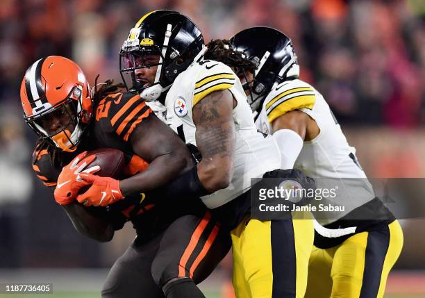 Running back Kareem Hunt of the Cleveland Browns is tackled by the defense of the Pittsburgh Steelers during the game at FirstEnergy Stadium on...