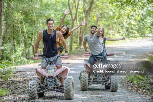 man and woman having fun on an off road adventure. - atv trail stockfoto's en -beelden