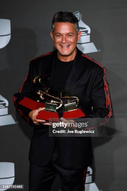 Musician Alejandro Sanz poses in the press room with the awards for Record of the Year, Best Pop Song and Best Long Form Music Video during the 20th...