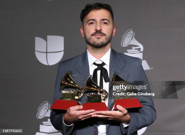 El Guincho poses with the Album of the Year, Best Urban Song and Best Engineered Album awards in the press room during the 20th annual Latin GRAMMY...