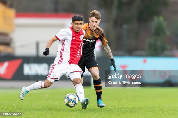 Naci Uenuevar of Ajax Amsterdam U19 and Xavi Estacio of FC Valencia U19 battle for the ball during the UEFA Youth League match between Ajax Amsterdam...