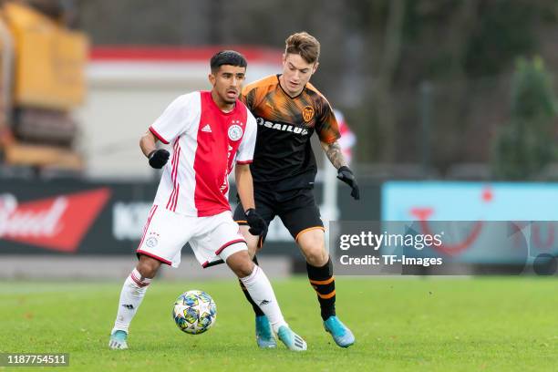 Naci Uenuevar of Ajax Amsterdam U19 and Xavi Estacio of FC Valencia U19 battle for the ball during the UEFA Youth League match between Ajax Amsterdam...