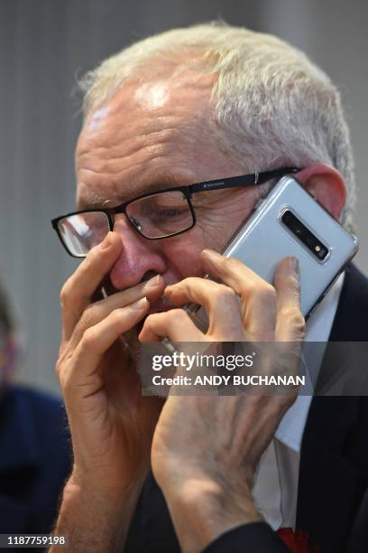 Opposition Labour party leader Jeremy Corbyn reacts as he speaks on the phone at a phone banking session in Glasgow, Scotland on December 10 as...