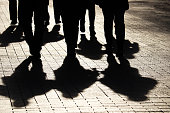 Silhouettes and shadows of people on the city street