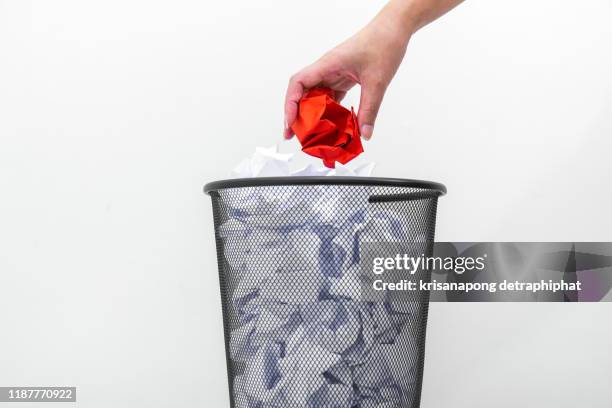 woman hand throwing crumpled paper in basket,littering, trash - crumpled paper ball stock-fotos und bilder