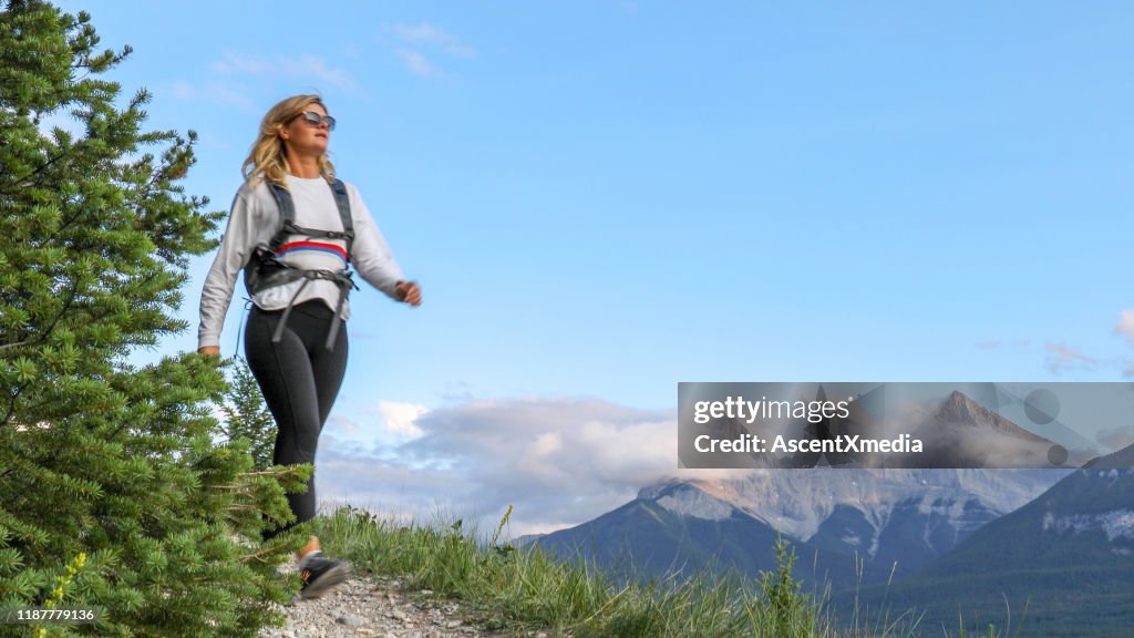 Young female hiker walks along footpath