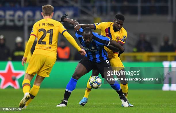 Moussa Wagué of FC Barcelona competes for the ball with Romelu Lukaku of FC Internazionale during the UEFA Champions League group F match between...