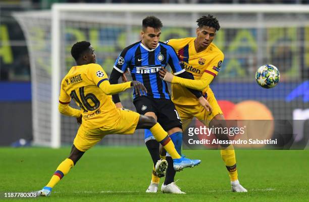 Laturaro Martinez of FC Internazionale competes for the ball with Moussa Wagué and Jean-Clair Todibo of FC Barcelona during the UEFA Champions League...