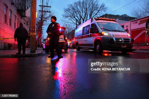 Police officers attend a emergency on the scene where active shooting is happening in Jersey City on December 10, 2019. - A shooting in a New York...