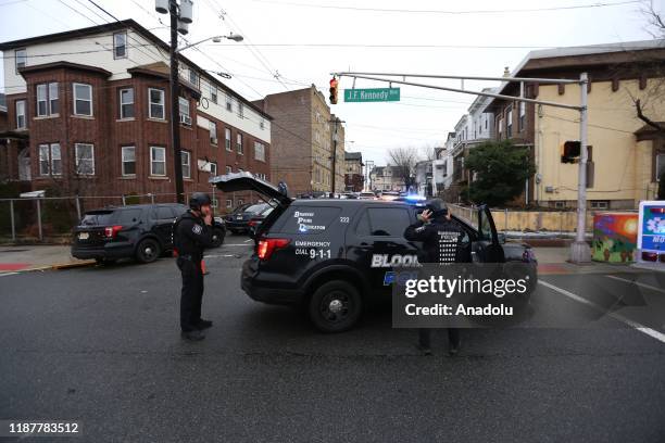 Security officers take security measures after multiple people, including a police officer, have been killed in a shootout in the U.S. State of New...