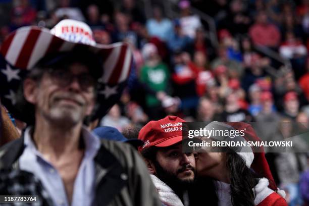 People listen as US President Donald Trump speaks during a Keep America Great rally at the Giant Center in Hershey, Pennsylvania on December 10, 2019.