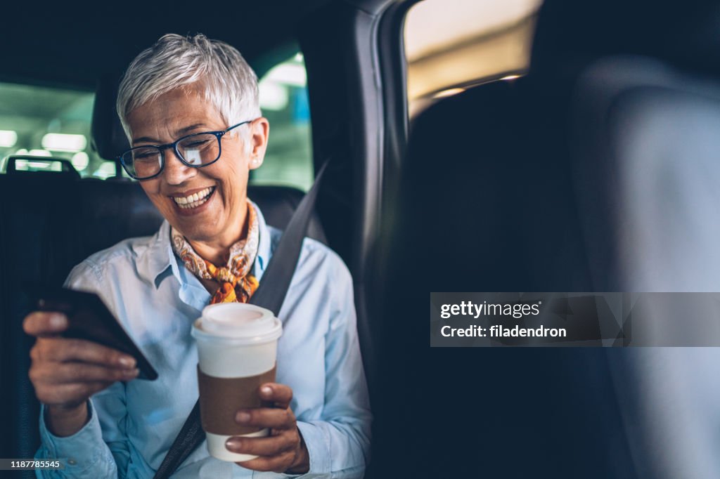 Woman with smartphone in the car