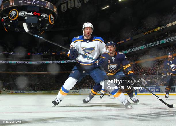 Troy Brouwer of the St. Louis Blues skates against Colin Miller of the Buffalo Sabres during an NHL game on December 10, 2019 at KeyBank Center in...