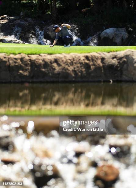 Louis Oosthuizen of South Africa lines up a putt on the 9th green during Day Two of the Nedbank Golf Challenge hosted by Gary Player at Gary Player...