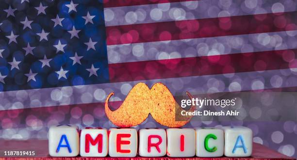 strong America,American mustaches ,Fist of USA (United States of America) flag  background,stronger American,text written America colorful written text America on mustache
