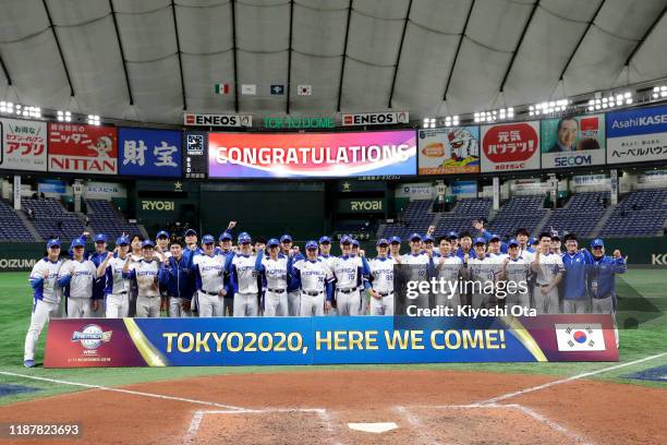 South Korean players pose for photographs as they celebrate qualified for the Tokyo 2020 Olympic Games after their victory in the WBSC Premier 12...