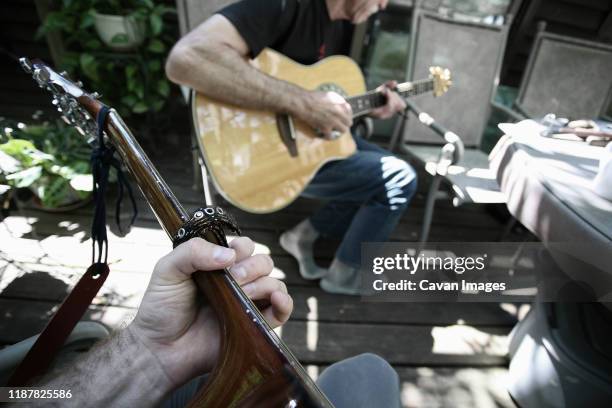 first person perspective playing guitar with another person. - jam session stock pictures, royalty-free photos & images