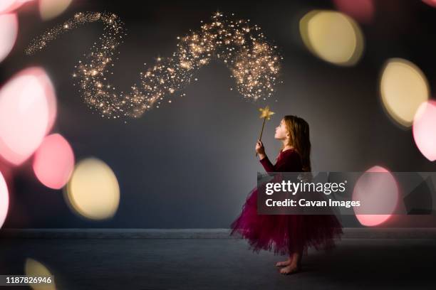 magical composite of young girl in fairy fancy dress outfit - photoshop photos et images de collection