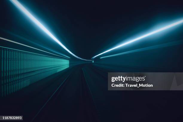 tunnel speed motion light trails - green and blue light stock pictures, royalty-free photos & images
