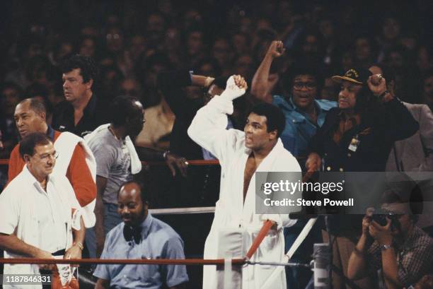 Olympic and three time heavyweight champion Muhammad Ali chants to the crowd and his opponent Larry Holmes as trainer Angelo Dundee looks on before...